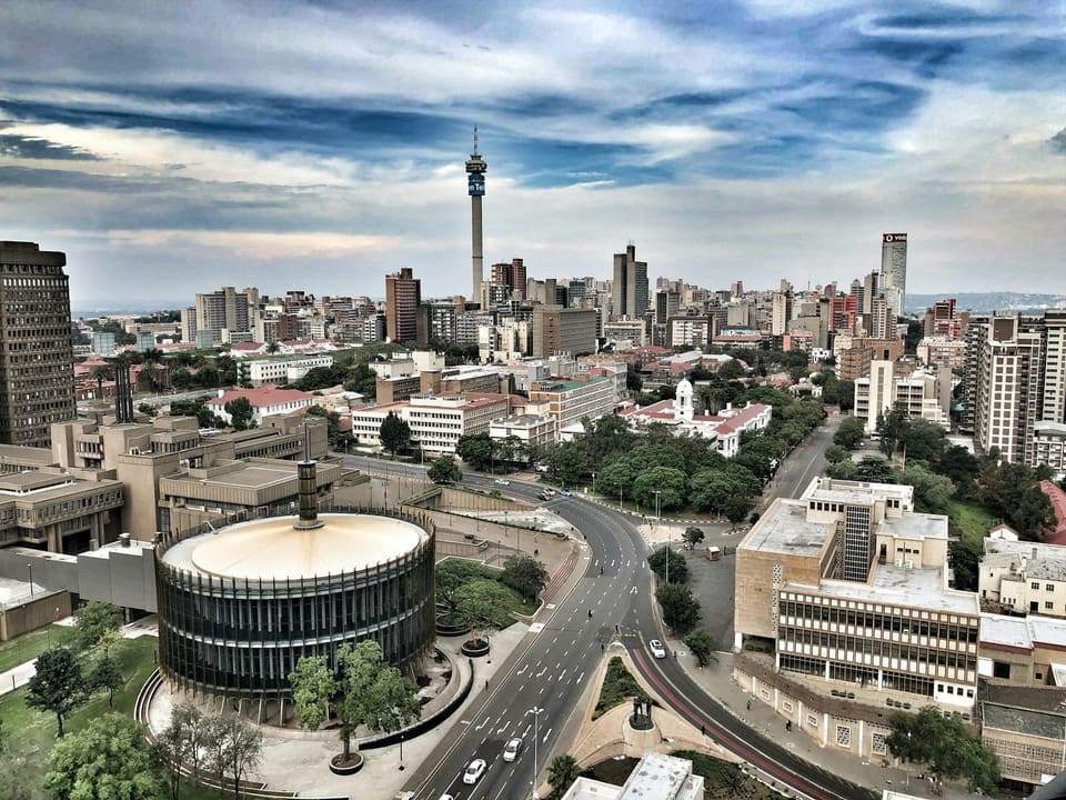 Aerial view of a South African city skyline at golden hour, representing nationwide procurement opportunities across all 9 provinces.